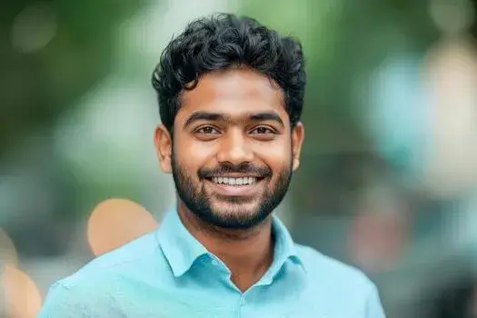 a smiling young indian man with formal shirts outdoors photo - WebPlover